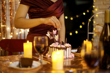 Woman preparing cake decoration for birthday celebration party at home