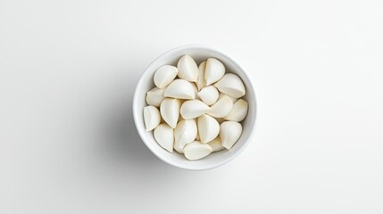 White bowl of garlic cloves, top view, isolated, clean white