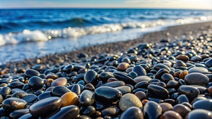 Obraz premium Black stones scattered on a pebble beach , serene, tranquil, nature, background, texture, shore, seaside, ocean, rocks