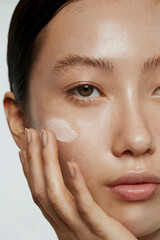 Stylish Minimalism, An extreme close-up shot of the eyes showcasing dewy skin around the eye area: The model's face is captured with a focus on the eyes, emphasizing the bright