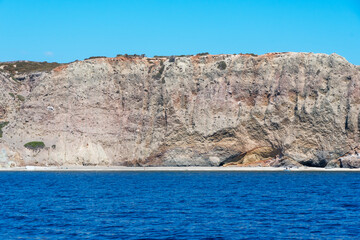 Rocky wall overlooking the sea in Milos, Cyclades Islands. Greece.