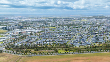 Drone aerial photograph of houses and infrastructure development in the fast growing suburb of Oran Park in the high density development region of western Sydney, NSW Australia.