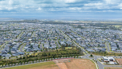 Drone aerial photograph of houses and infrastructure development in the fast growing suburb of Oran Park in the high density development region of western Sydney, NSW Australia.