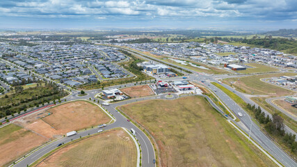 Drone aerial photograph of houses and infrastructure development in the fast growing suburb of Oran Park in the high density development region of western Sydney, NSW Australia.