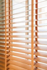 Wooden shutters and blinds let in sun rays, adding a decorative touch to the interior of the room.