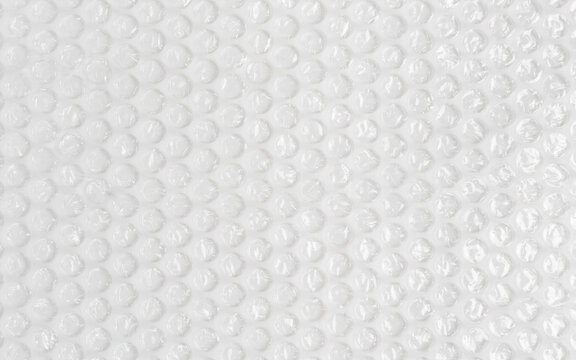 Background texture of plastic bubble wrap used for packing and protecting products from bumps and scratches.