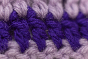 close-up of horizontal crochet stitches in royal purple with lilac purple stitches, crocheted or knitted, reminds you of grandma's house, cozy and warm background, macro