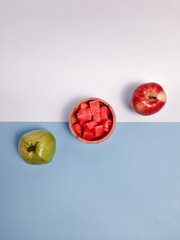 Fresh papaya, apple, and guava on colorful background