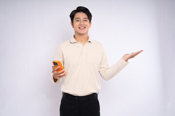 Portrait of young asian businessman wearing sweater and using phone on white background