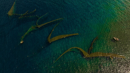 Fishermen spread nets to catch fish at Chan May beach, Hue, in the middle of the vast sea and the turquoise water is truly beautiful. Photo taken in Hue on June 25, 2023.