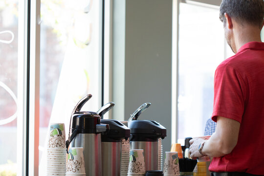 Man getting coffee in church lobby before worship service