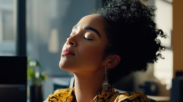 woman sitting at desk with head tilted back, eyes closed, and mouth slightly open, appearing to fall asleep during workday. Tired office worker amidst stress and fatigue in typical office
