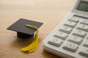 Mortarboard and calculator. Money financial management and planning for education, student debt or...