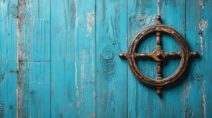 An old wooden ship wheel mounted on a weathered blue wood background.