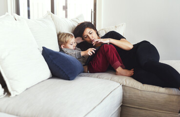 Mother, tablet and child on couch in family home with digital, game video and streaming in living...
