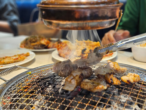 Copper metal exhaust fan and system in the Korean barbeque restaurant with the meat grilling with smoke.