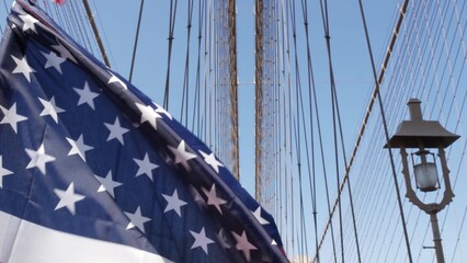 American flag on Brooklyn Bridge to Manhattan, New York City. Patriotic symbol of liberty, freedom,...