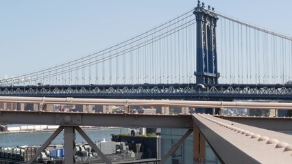 New York City Manhattan Bridge from Brooklyn Bridge view. USA travel landmark, NYC skyline cityscape. Iconic architecture over East River water. Visit United States of America.