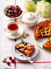 Cherry, red berry sweet pie, cake with cup of tea. White background. Close up.