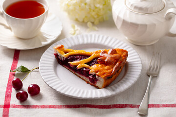 Cherry, red berry sweet pie, cake with cup of tea. White background. Close up.