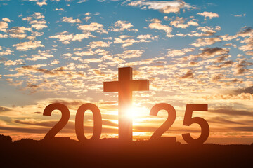 Silhouette of Christian cross with 2025 years at sunset background. Concept of Christians new year 2025