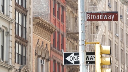 Broadway street road sign, Manhattan midtown property, red brick house architecture, New York City real estate. One way traffic roadsign. Ladies mile historic district, United States.