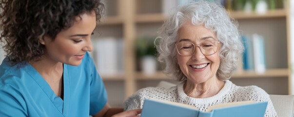 A woman in a blue shirt is reading a book with a woman in a white shirt