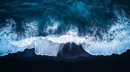 Fototapeta premium An aerial view of the ocean waves crashing, Dark beach view