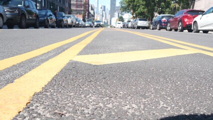 New York City skyline, Manhattan Midtown cityscape. High-rise skyscrapers from Queens, Long Island, Hunters Point, USA. Cars on street, yellow dividing line, road marking. United States architecture.