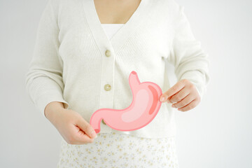 woman hands holding stomach, heartburn, Gastroesophageal reflux disease (GERD) or acid reflux...