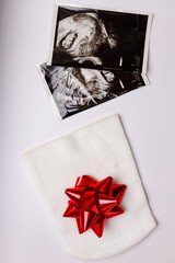 Newborn white hat and prenatal screening images with baby on a white background