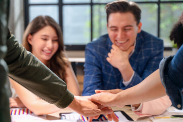 Businesspeople group are join hands for working after the job success.
