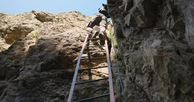 Hiker Climbing Up Ladder At Grignetta Mountain In Italy - Tracking Shot