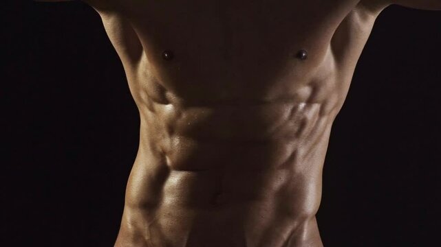 Strong male model, sexy sports athlete fitness personal trainer. Perfect abs, shoulders, and chest. Man with naked torso showing six pack abs. Fitness man showing muscular fitness body.