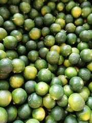 Limes: The third image shows a cluster of small, round limes in shades of green with slight yellow hints. The limes have a dimpled texture, conveying their freshness and zesty flavor.