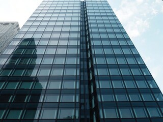 Fototapeta premium Modern glass facade of a skyscraper in the city center, skyline, urban, financial district