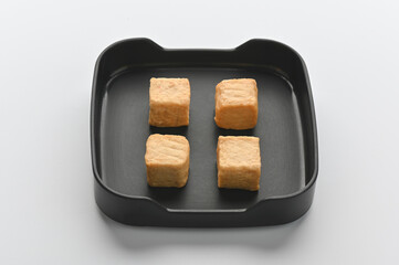 Meatballs in black tray on white background.