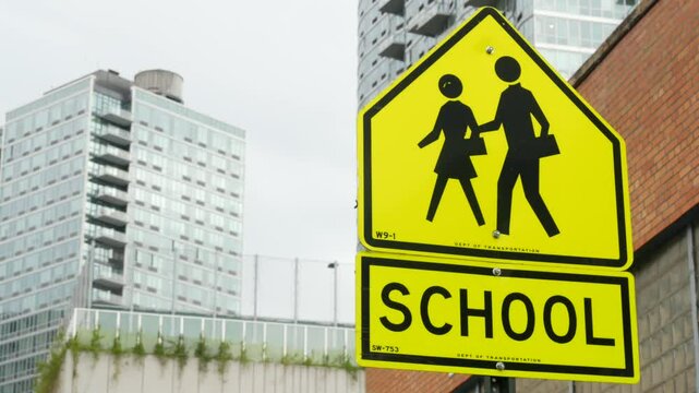 School zone yellow road sign, pedestrian crossing. Children safety on street, New York City. Transport and education symbol, USA . Traffic roadsign in Queens, Long Island, Hunters point.