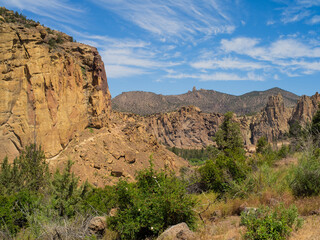 A mountain range with a clear blue sky and a few trees