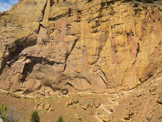 A rocky cliff with a path leading up to it