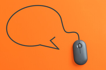 For communication concept, top view of black computer mouse with blank speech bubble shape  on...