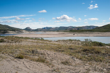 Kangerlussuaq Fjord and Greenlandic Mountains, This breathtaking image showcases Kangerlussuaq Fjord, framed by the stunning Greenlandic mountains during the vibrant summer month of June.