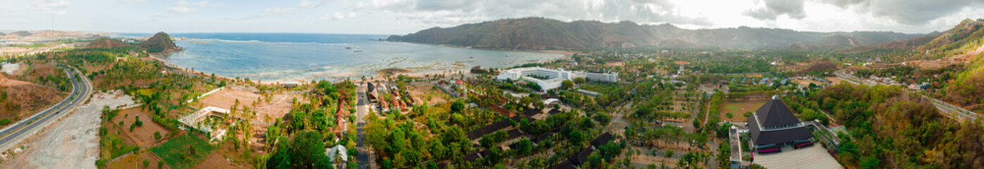 Obraz premium Panoramic aerial drone view of stunning Kuta Beach or Pantai Kuta in Kuta Mandalika, Lombok, Indonesia