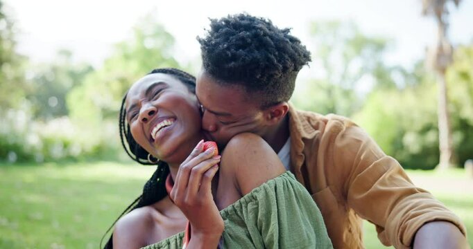 Park, black couple and smile on picnic with strawberry on date for fun, support or bonding in Kenya. People, relationship and happy or laughing at garden with fruit for care, love or trust on break