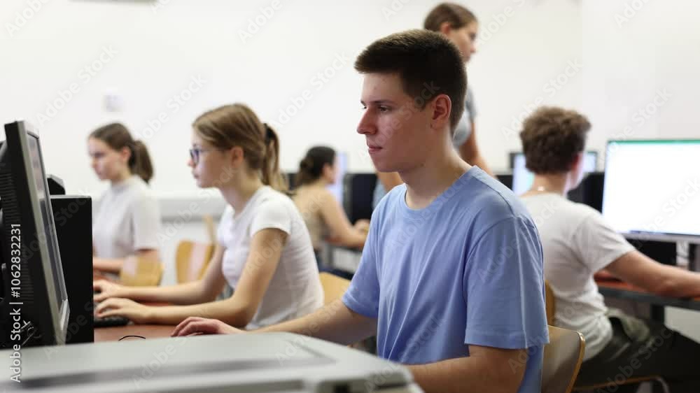 Poster positive male student using pc and studying computer science in the classroom