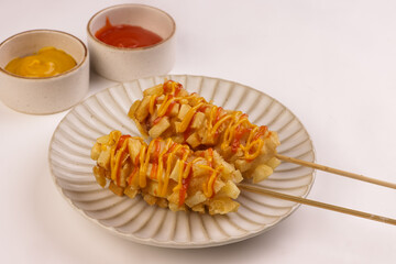 Potato Corn Dogs is Korean Style Chunky Corn Dogs with Batter and Fried Potatoes.