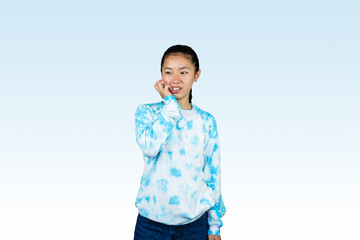 Yougn Asian girl with blue dress points and gives various expression and gestures isolated happy sad