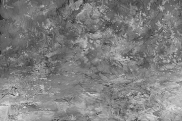 Chaotic strokes of acrylic paint on paper as an abstract background. Black and white image.