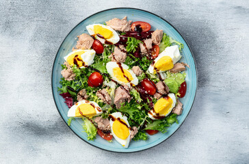 Canned Tuna salad with eggs and tomatoes photography . Top view