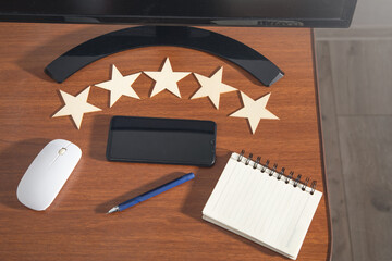 Wooden 5 stars on the workplace. Customer satisfaction